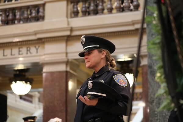 Officer Holding Fallen Cap 2018